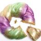 A golden baby Jesus inside Sucre's King Cake.