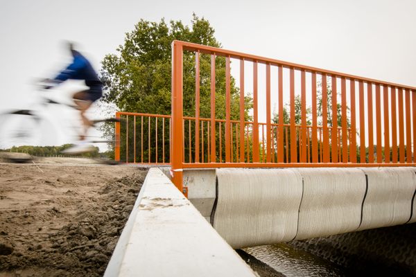 A cyclist rides over one of the world’s first 3D-printed concrete bridge after its opening in Gemert, The Netherlands in 2017.