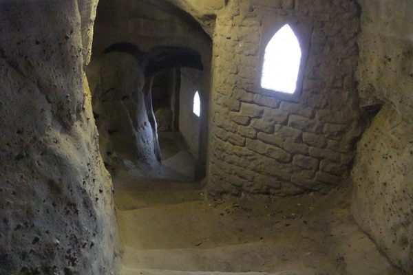 Tunnel with steps cut into a cliff face.
