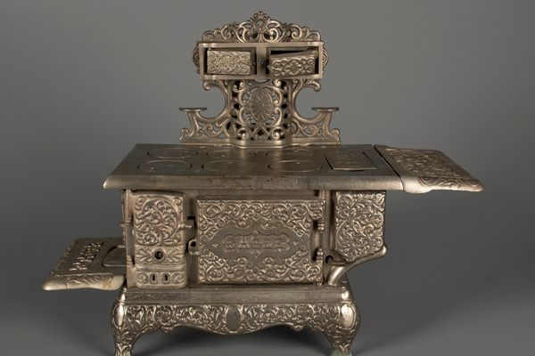 This 1920 Eagle toy stove by Hubley Manufacturing Company features a working damper and came with a waffle iron. 