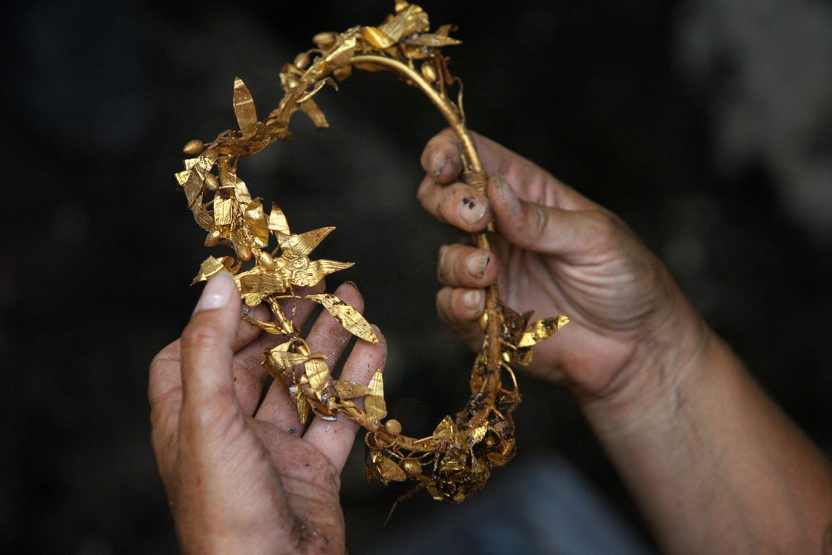 An archaeologist holds a golden crown found in a Thracian king's tomb. It dates back to the fourth century BC.